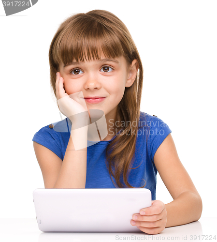 Image of Young girl is using tablet