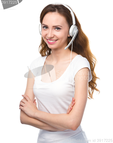 Image of Lovely young woman is talking to customers