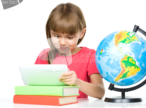 Image of Young girl is using tablet