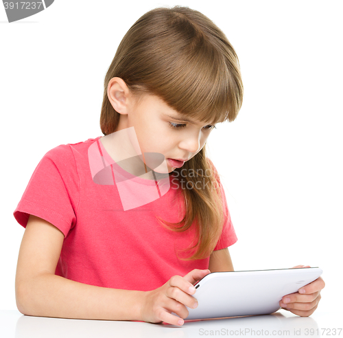 Image of Young girl is using tablet