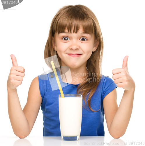 Image of Cute little girl with a glass of milk