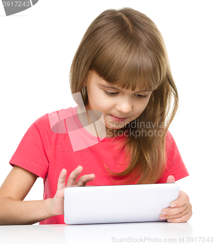 Image of Young girl is using tablet