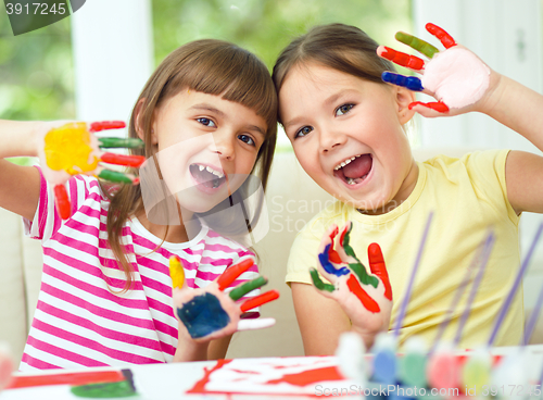 Image of Little girls are painting with gouache