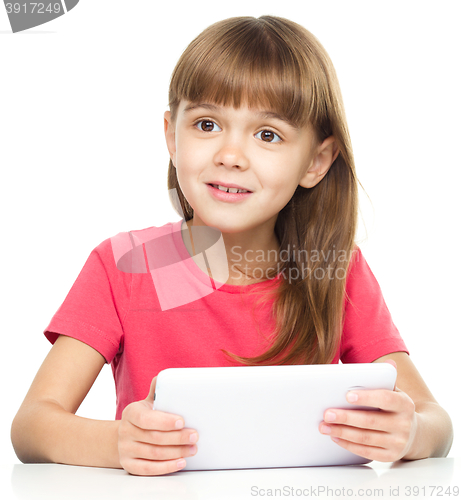 Image of Young girl is using tablet
