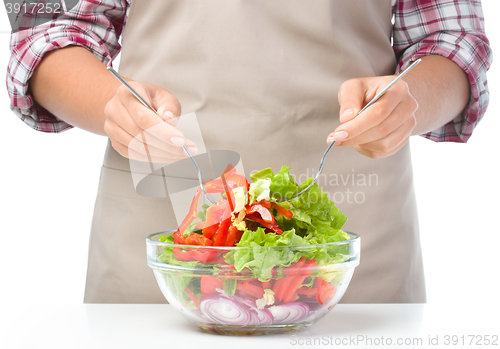 Image of Cook is mixing salad