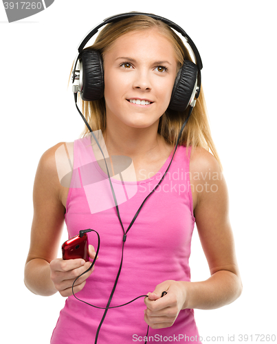 Image of Teen girl enjoying music using headphones