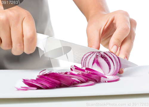 Image of Cook is chopping onion