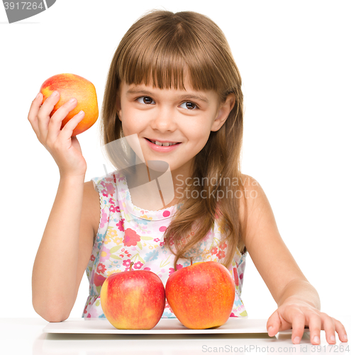 Image of Little girl with red apples