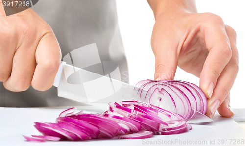 Image of Cook is chopping onion