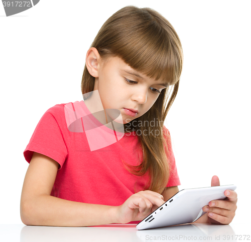 Image of Young girl is using tablet