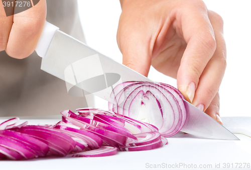 Image of Cook is chopping onion