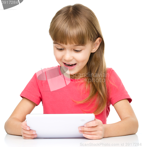 Image of Young girl is using tablet