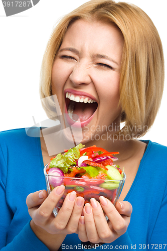 Image of Young happy woman with salad