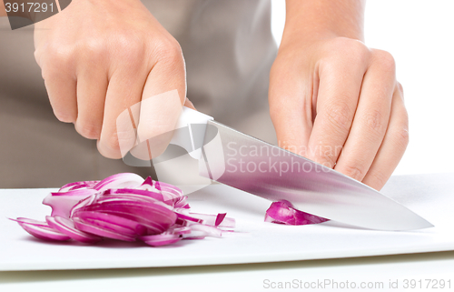 Image of Cook is chopping onion