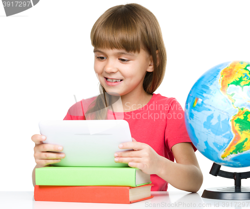 Image of Young girl is using tablet