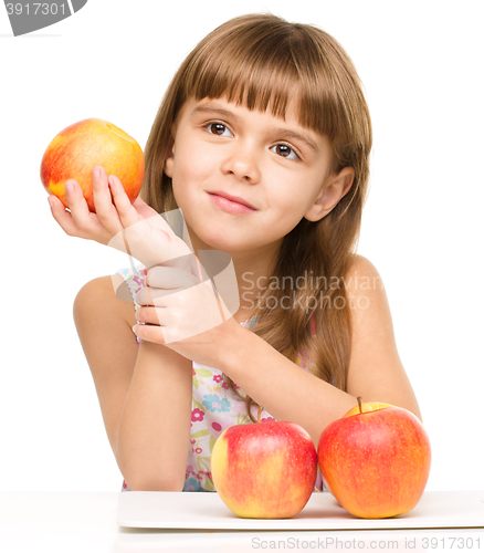 Image of Little girl with red apples