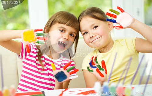 Image of Little girls are painting with gouache