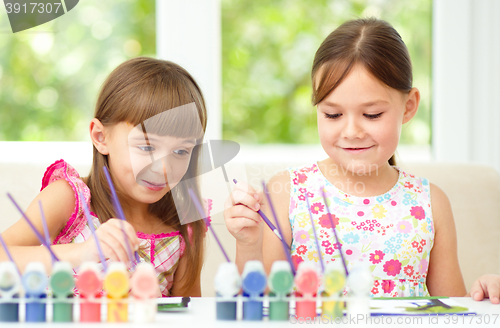 Image of Little girls are painting with gouache