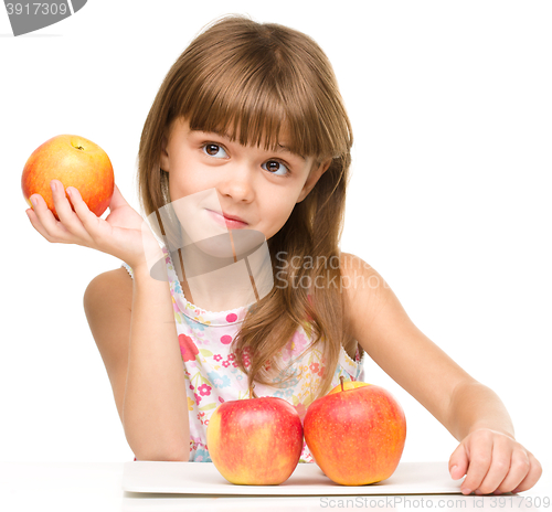 Image of Little girl with red apples