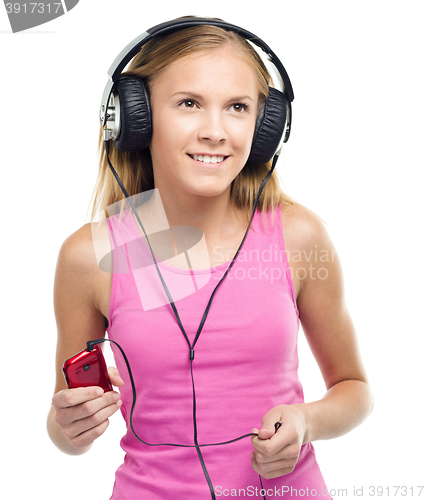 Image of Teen girl enjoying music using headphones