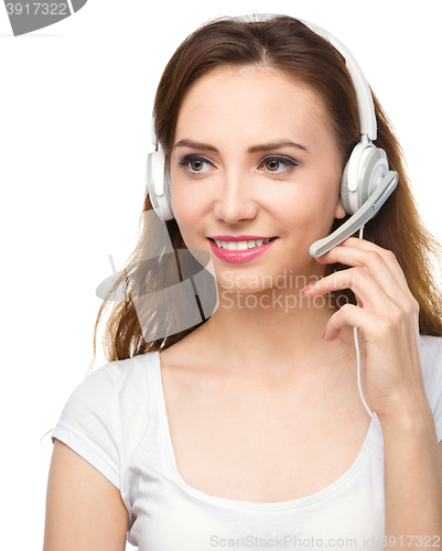 Image of Lovely young woman is talking to customers