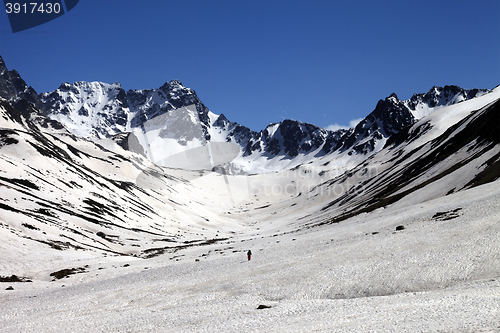 Image of Hiker in snowy mountains at nice day