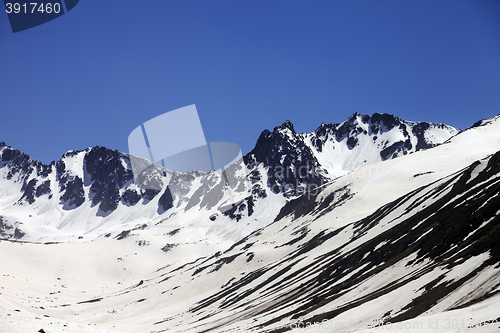 Image of Snowy mountains at nice spring day