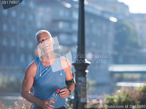 Image of portrait of handsome senior jogging man