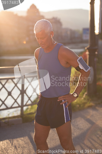 Image of portrait of handsome senior jogging man