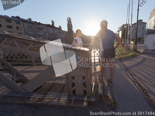 Image of jogging couple planning running route  and setting music