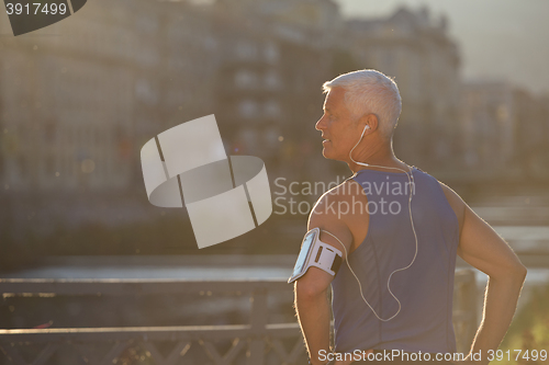 Image of portrait of handsome senior jogging man