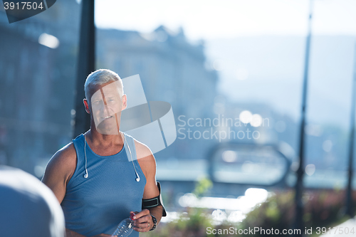 Image of portrait of handsome senior jogging man