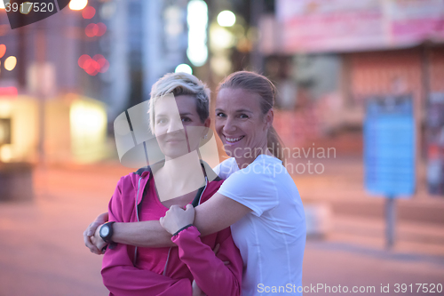 Image of couple warming up before jogging