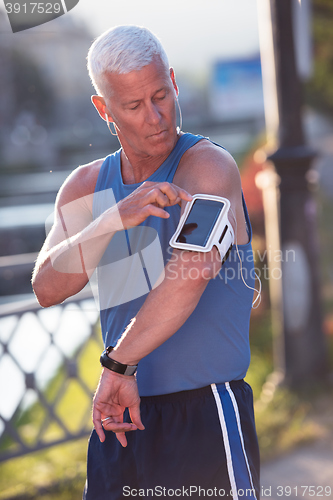 Image of portrait of handsome senior jogging man