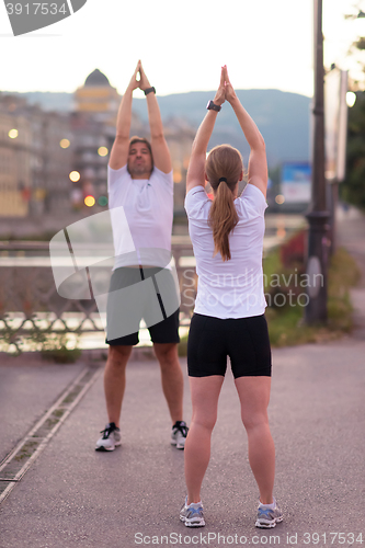 Image of couple warming up before jogging