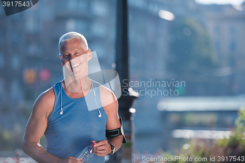 Image of portrait of handsome senior jogging man
