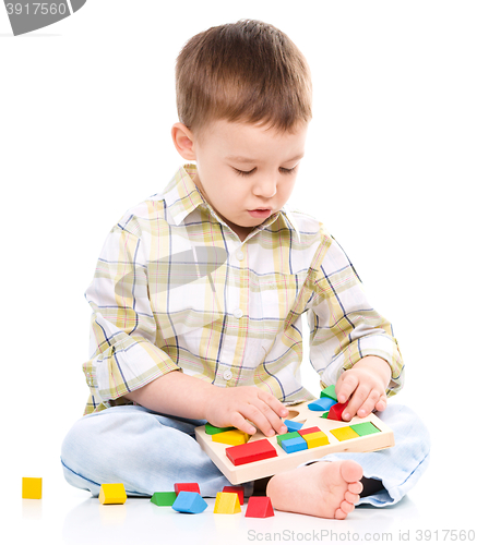 Image of Little boy is playing with toys