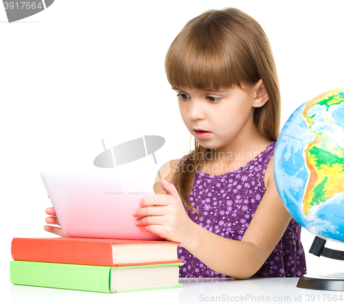 Image of Young girl is using tablet