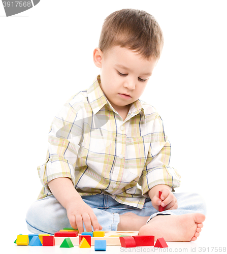 Image of Little boy is playing with toys