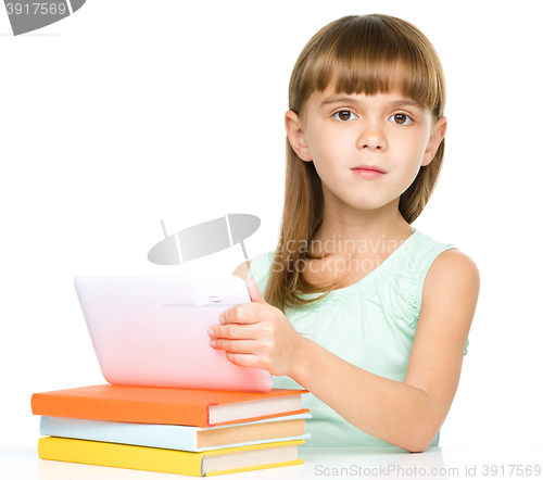 Image of Young girl is using tablet