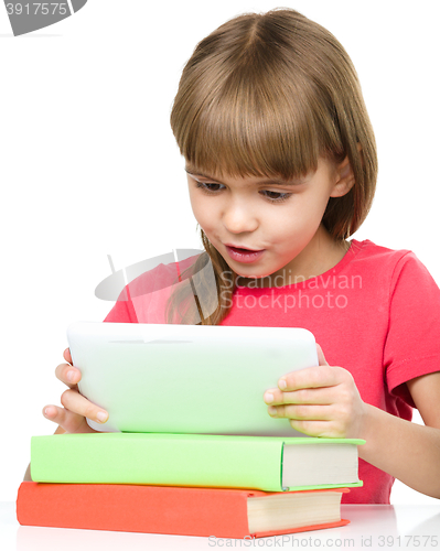 Image of Young girl is using tablet