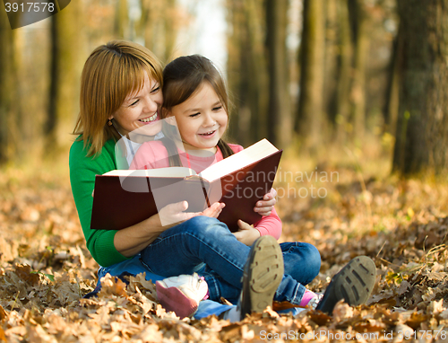Image of Mother is reading book with her daughter