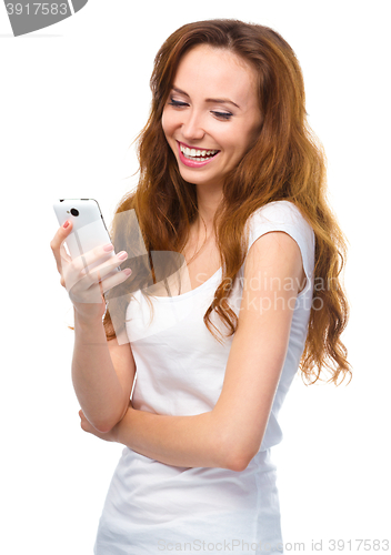 Image of Young woman is pleased by incoming message