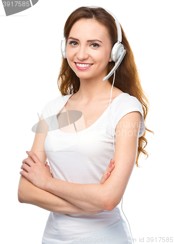 Image of Lovely young woman is talking to customers