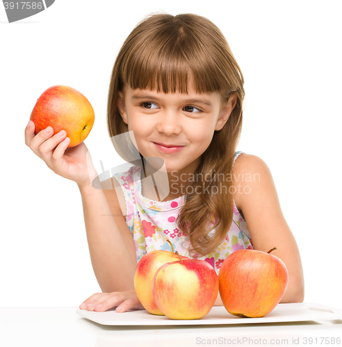 Image of Little girl with red apples