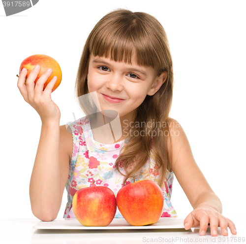 Image of Little girl with red apples