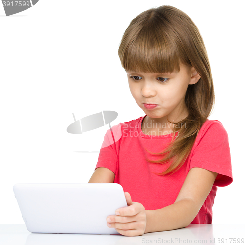 Image of Young girl is using tablet