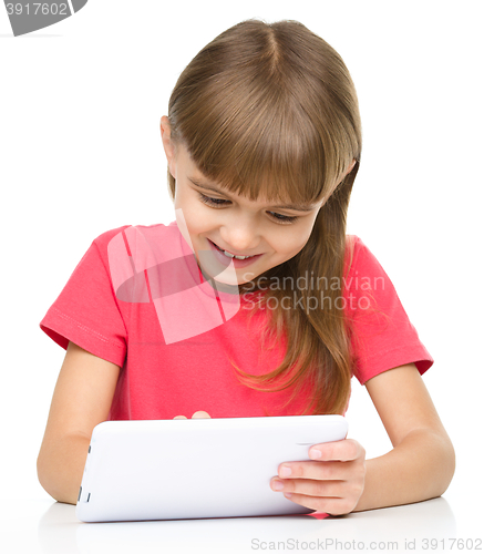 Image of Young girl is using tablet