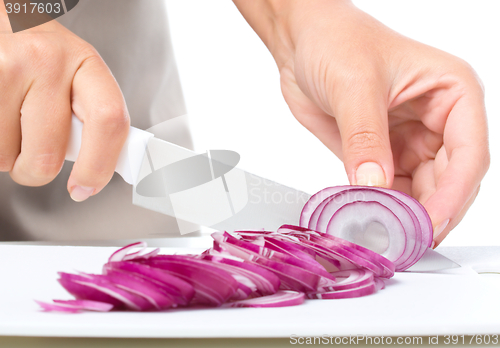 Image of Cook is chopping onion