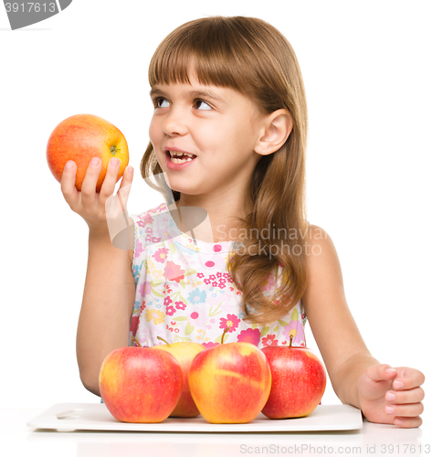 Image of Little girl with red apples